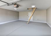 Thumbnail 19 of 23 - A room with a ladder and a light fixture on the ceiling.