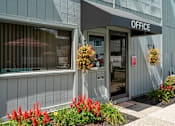 Thumbnail 13 of 20 - A grey building with a sign that says "OFFICE" on the front.