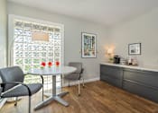 Thumbnail 4 of 16 - A dining room with a table, chairs, and a window with a lattice design.