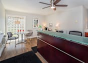 Thumbnail 3 of 16 - A reception area with a desk and chairs.