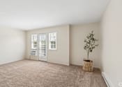 Thumbnail 12 of 17 - A room with a carpeted floor and a tree in a basket.