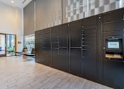 Thumbnail 20 of 34 - a row of black lockers in a hallway with a wood floor