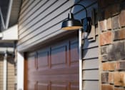 Thumbnail 22 of 23 - A black lamp is mounted on a house.