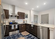 Thumbnail 16 of 62 - a kitchen with stainless steel appliances and a white counter top at 41 North Apartments, Fort Wayne Indiana