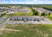 Thumbnail 21 of 62 - an aerial view of an apartment complex with a parking lot and a lake at 41 North Apartments, Fort Wayne, 46835