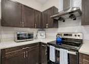 Thumbnail 7 of 62 - a kitchen with a stove top oven and a microwave at 41 North Apartments, Fort Wayne, IN 46835