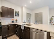 Thumbnail 29 of 62 - a kitchen with a large counter top and stainless steel appliances at 41 North Apartments, Fort Wayne Indiana