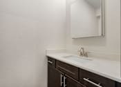 Thumbnail 24 of 62 - an empty bathroom with a sink and a mirror at 41 North Apartments, Indiana