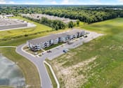 Thumbnail 19 of 62 - a view of a building from the air with a road and a parking lot at 41 North Apartments, Indiana, 46835