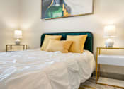 Thumbnail 38 of 62 - the master bedroom has a large bed and a painting on the wall at 41 North Apartments, Indiana