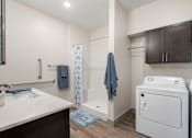Thumbnail 50 of 62 - a bathroom with a sink and a shower and a washer and dryer at 41 North Apartments, Indiana