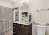 Thumbnail 15 of 62 - a bathroom with a toilet and a sink and a mirror at 41 North Apartments, Fort Wayne, IN