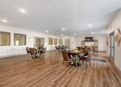 Thumbnail 27 of 62 - a large living room with a dining room table and chairs at 41 North Apartments, Fort Wayne, IN