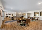Thumbnail 45 of 62 - a large living room with a dining area and a kitchen with a table and chairs at 41 North Apartments, Indiana, 46835