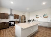 Thumbnail 59 of 62 - a large white kitchen with a large island and stainless steel appliances at 41 North Apartments, Fort Wayne, IN 46835