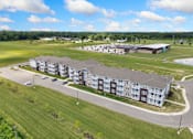 Thumbnail 25 of 62 - an aerial view of an apartment building next to a field at 41 North Apartments, Indiana, 46835