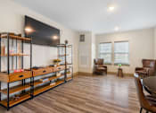 Thumbnail 9 of 62 - a living room with a tv and a table and chairs at 41 North Apartments, Fort Wayne, 46835
