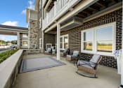Thumbnail 5 of 62 - Balcony with chairs and a rug at 41 North Apartments, Fort Wayne