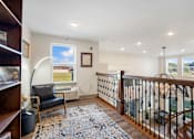 Thumbnail 11 of 62 - a lounge area with a staircase and a chair and a window at 41 North Apartments, Fort Wayne