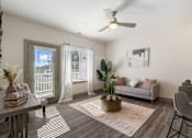 Thumbnail 10 of 62 - an open living room and dining room with a ceiling fan and sliding glass doors at 41 North Apartments, Fort Wayne Indiana