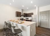 Thumbnail 55 of 62 - a kitchen with a large island with chairs and a counter top at 41 North Apartments, Fort Wayne Indiana