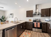 Thumbnail 46 of 62 - a large kitchen with stainless steel appliances and wooden cabinets at 41 North Apartments, Fort Wayne, IN 46835