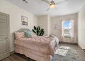 Thumbnail 49 of 62 - a bedroom with a bed and a ceiling fan at 41 North Apartments, Fort Wayne Indiana