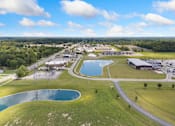 Thumbnail 57 of 62 - an aerial view of a park with a pond and buildings at 41 North Apartments, Indiana