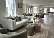 Thumbnail 13 of 19 - A living room with a couch, chairs, and a coffee table.