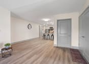 Thumbnail 19 of 43 - a living room and dining room with white walls and wood flooring at Morada at Maysville, Fort Wayne