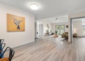Thumbnail 30 of 43 - the living room and dining room in a new home with white walls and wood floors at Morada at Maysville, Fort Wayne, IN