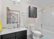 Thumbnail 21 of 43 - a bathroom with a sink toilet and shower and a mirror at Morada at Maysville, Indiana, 46815