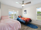Thumbnail 25 of 43 - a bedroom with a bed and a ceiling fan at Morada at Maysville, Fort Wayne Indiana