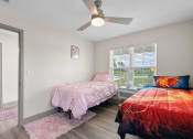 Thumbnail 12 of 43 - a bedroom with two beds and a ceiling fan at Morada at Maysville, Fort Wayne