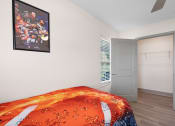 Thumbnail 33 of 43 - a bedroom with a bed and a door to a closet at Morada at Maysville, Fort Wayne
