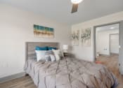 Thumbnail 16 of 43 - a bedroom with a large bed and a ceiling fan at Morada at Maysville, Fort Wayne, IN