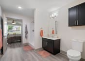 Thumbnail 29 of 43 - a bathroom with a toilet and a sink and a mirror at Morada at Maysville, Fort Wayne, IN 46815
