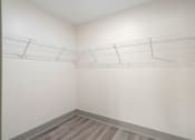 Thumbnail 40 of 43 - an empty closet with white walls and wooden floors and a wire rack on the wall at Morada at Maysville, Fort Wayne