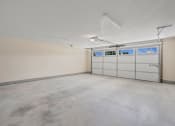 Thumbnail 36 of 43 - the interior of a garage with white walls and white garage doors at Morada at Maysville, Fort Wayne, IN 46815