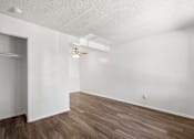 Thumbnail 35 of 40 - A room with wooden floors and white walls.