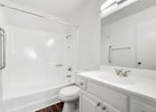 Thumbnail 40 of 40 - A white bathroom with a toilet, sink, and bathtub.