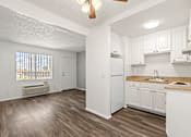 Thumbnail 32 of 40 - A kitchen with white cabinets and a white refrigerator.