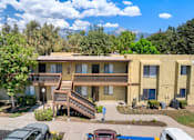 Thumbnail 2 of 40 - Apartment building with a mountain in the background.