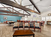 Thumbnail 20 of 40 - A large room with wooden floors and furniture.