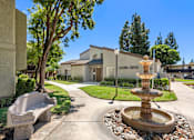 Thumbnail 4 of 40 - A fountain is in front of a leasing center.