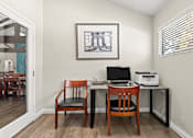 Thumbnail 29 of 40 - A room with a desk, chair and a picture on the wall.