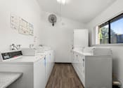 Thumbnail 30 of 40 - A clean, white-walled medical or laboratory room with a bench and a couple of cabinets.