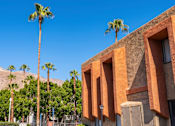 Thumbnail 8 of 16 - A building with a desert landscape in the background.