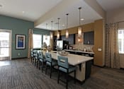 Thumbnail 14 of 50 - A kitchen with a long table and chairs.