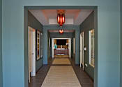 Thumbnail 19 of 50 - A long hallway with a light at the end.